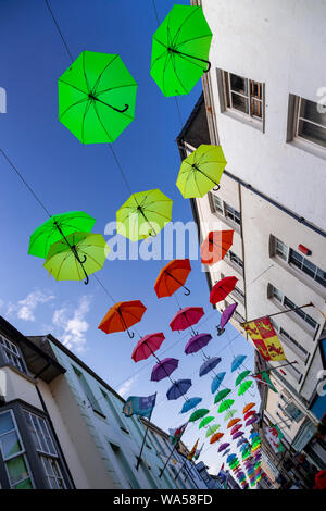 Multi-coloured umbrellas over Palace Street, Caernarfon, North Wales Stock Photo
