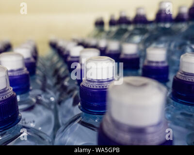Plastic bottles with wate. Rows of water-filled plastic bottles with screw caps. Stock Photo