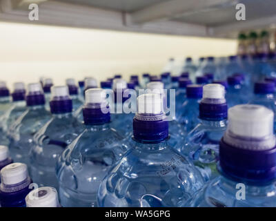 Plastic bottles with wate. Rows of water-filled plastic bottles with screw caps. Photo contains noise Stock Photo