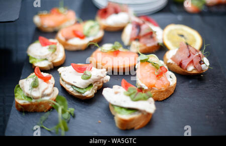 Beautifully decorated catering banquet table with different food snacks and appetizers. Stock Photo