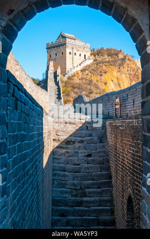 Vertical photography of a majestic watch tower with arch in the foreground along the Jinshanling Great Wall of China at sunset near Beijing, Asia. Stock Photo