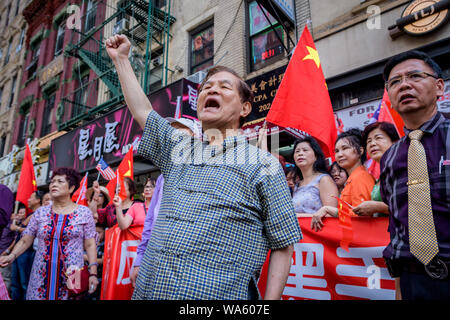 An equally strong counterprotest calling for ONE CHINA was held right across the street. - Hundreds joined activist group New Yorkers Supporting Hong Kong (NY4HK) at a rally on August 17, 2019 at Confucius Plaza, in Chinatown followed by a march to Manhattan Bridge Small Park, to show support for Hong Kong's ongoing pro democracy struggle. This was timed to coincide with the ‘Civil Human Rights Front' rally in Victoria Park Hong Kong as well as three other planned protests taking place in Hong Kong this weekend. (Photo by Erik McGregor/Pacific Press) Stock Photo