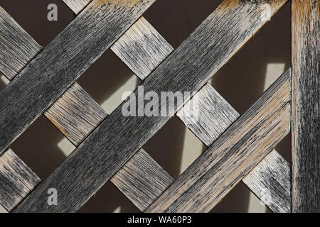 old distressed wood on a weather beaten lattice frame in spring in Italy Stock Photo