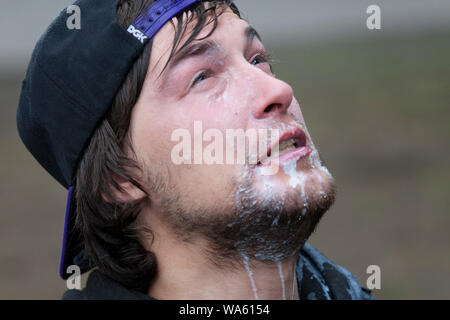 A protester is doused with milk after being pepper sprayed by the Portland Police during the “End Domestic Terrorism” rally at Tom McCall Waterfront Park on August 17, 2019 in Portland, Oregon. Organized as a protest against anti-fascists by right-wing radio host Joe Biggs and members of the Proud Boys, the rally attracted a large contingent of counterprotesters including Rose City Antifa. Stock Photo