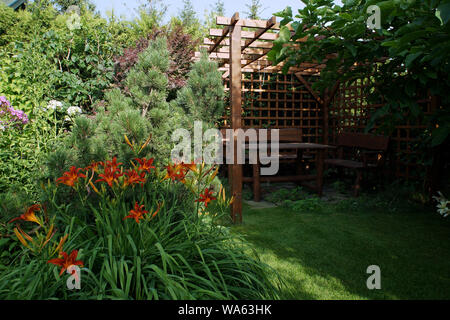 Wooden garden gazebo with chairs and table Stock Photo