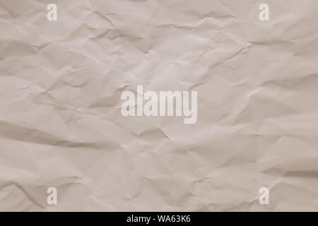 Crumpled vintage paper background. Texture of creased beige sheet. Wrinkled page, pattern. Copy space. Light pink wrinkle cardboard surface. Carton su Stock Photo