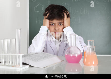 Schoolboy experimenting in a chemistry lab Stock Photo