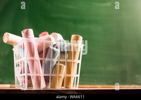 Many colorful piece of chalk in plastic basket. Back to school concept. Beginning school year. Closeup view with copy space. Selective focus Stock Photo