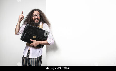 Joyfull nerd holding a brief case - standing next to the empty board Stock Photo