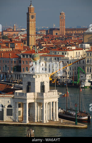 Venice Italy in the morning sun: The Dogana da Mar building. Atop the building are two statues of Atlas holding a golden globe upon which 's Fortune s Stock Photo