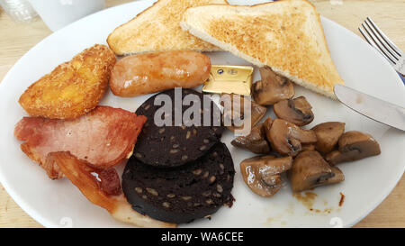 traditional full English breakfast on a white plate Stock Photo