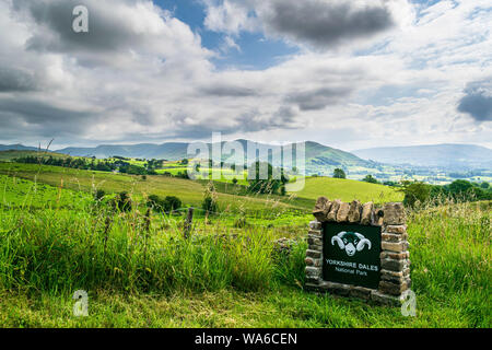 Yorkshire Dales National Park sign with mountains behind Stock Photo