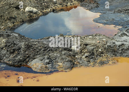 Former dump toxic waste, effects nature from contaminated soil and water with chemicals and oil, environmental disaster, contamination Stock Photo