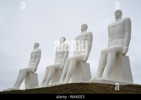 Men at Sea, Man Meets the Sea monument, landmark in Esbjerg, Denmark. 9 meters, 30 ft tall white sculpture of four seated males, overlooking the beach Stock Photo