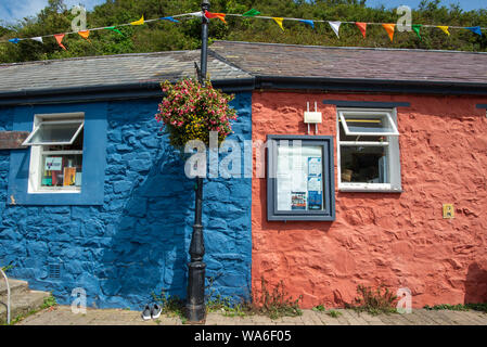 Fishguard, Wales, UK - Aug 12, 2019: Red house and blue house attached to each other in the old port of Fishguard Stock Photo
