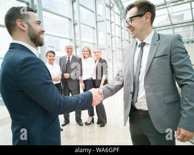 Handshake of business people in the lobby of an office building Stock Photo