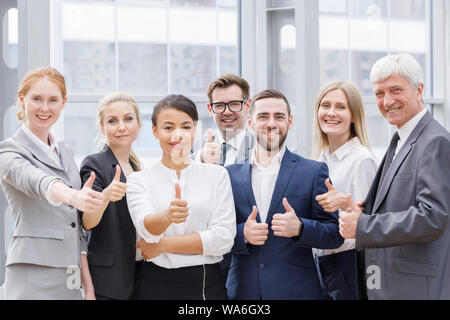 Portrait business people team showing thumbs up , office staff standing in lobby Stock Photo