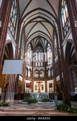 Warsaw, Poland - May 12, 2019: High altar in Cathedral of St. Michael the Archangel and St. Florian the Martyr interior, Gothic Revival style city lan Stock Photo