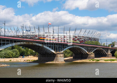 Warsaw, Poland - July 7, 2019: Poniatowski Bridge (Polish: Most Poniatowskiego) on Vistula River and National Stadium PGE Narodowy in the background. Stock Photo