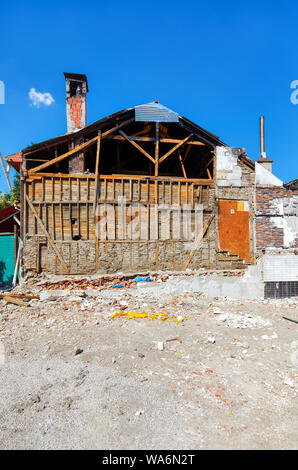 Old abandoned and ruined industrial building with wooden walls Stock Photo