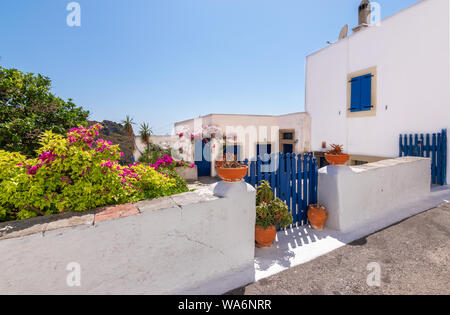 Chora town with white Greek house, courtyard and decorative pottery along the street, Kythira Island, Greece. Stock Photo