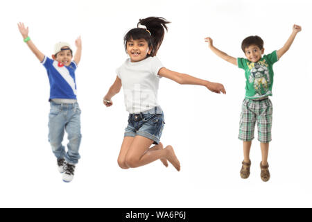 Group of friends jumping in air with arm outstretched Stock Photo