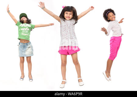 Group of friends jumping in air with arm outstretched Stock Photo