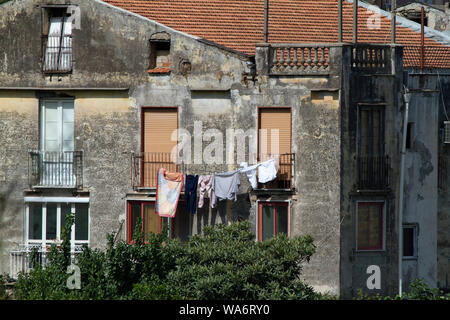 Washing hanging on a line outside a near derelict building in Sorrento, Italy Stock Photo