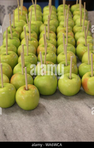 ripe green apples with a stick ready for caramel coating and nuts Stock Photo