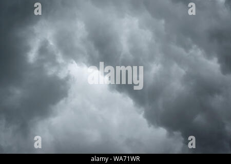 Dark sky with thunderstorm while raining. Dramatic black clouds before the rain. Stock Photo