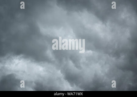Dark sky with thunderstorm while raining. Dramatic black clouds before the rain. Stock Photo