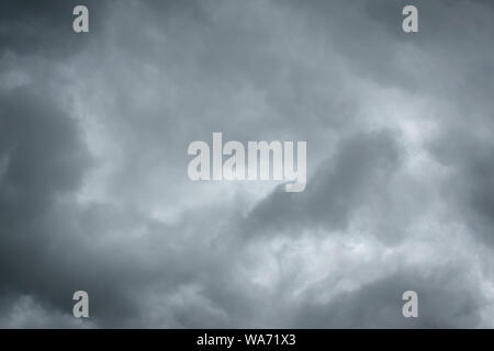 Dark sky with thunderstorm while raining. Dramatic black clouds before the rain. Stock Photo