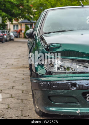 Car crash or accident. Front fender and light damage and scratchs on bumper. Broken vehicle detail or close up. Stock Photo