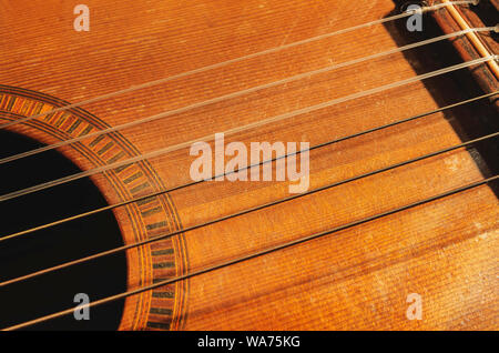 Shapes and lines of an old acoustic guitar sound hole part of the