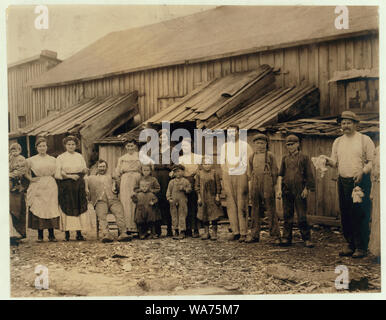 We give them houses to live in. About 50 persons housed in this miserable row of dilapidated shacks. Located on an old shell-pile and partly surrounded by a tidal marsh. Maggioni Canning Co. Abstract: Photographs from the records of the National Child Labor Committee (U.S.) Stock Photo