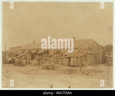 We give them houses to live in, About 50 persons housed in this miserable row of dilapidated shacks. Located on an old shell-pile and partly surrounded by a tidal marsh. Maggioni Canning Co. Abstract: Photographs from the records of the National Child Labor Committee (U.S.) Stock Photo