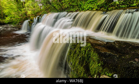 A scenic waterfall surrounded by forest in South Wales (Sgwd y Pannwr, Waterfall country, Wales) Stock Photo