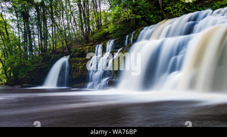 A scenic waterfall surrounded by forest in South Wales (Sgwd y Pannwr, Waterfall country, Wales) Stock Photo