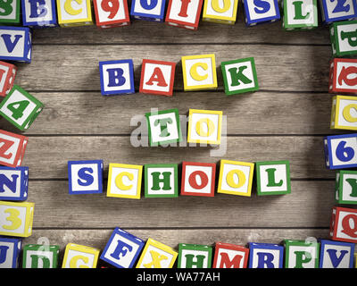 Wooden alphabet blocks arranged into Back to School text on wooden plank surface shot from above Stock Photo