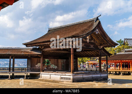 Japan, Miyajima. Itsukushima Shrine. The Noh stage, from 1680, constructed in Ichiju-kiritsuma style with thatched cypress roof. Tide out. Stock Photo