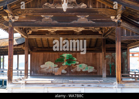 Japan, Miyajima. Itsukushima Shrine. The Noh stage, from 1680. Close up, showing paintings on back wooden wall and ceiling construction details. Stock Photo