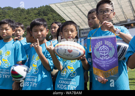 Kamaishi, Japan. 18 August 2019.  Elementary-school children from Taiwan pose for the cameras during the ''Kamaishi Kids Try'' sports event at Kamaishi Unosumai Memorial Stadium. The ''Tohoku Media Tour: Iwate Course'' is organized by the Tokyo Metropolitan Government in collaboration with local authorities to showcase the recovery efforts in Tohoku area affected by the 2011 Great East Japan Earthquake and Tsunami.  The memorial Credit: ZUMA Press, Inc./Alamy Live News Stock Photo