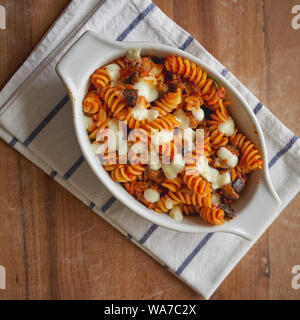 A homemade dish of fusilli pasta 'alla Norma', a Sicilian dish made with fried aubergines, mozzarella or ricotta cheese, tomato sauce and basil. Stock Photo