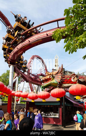 Tivoli Gardens Copenhagen - people enjoying the rollercoaster ride in the amusement park; Tivoli, Copenhagen Denmark Europe Stock Photo