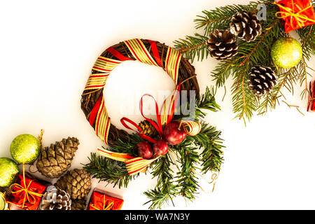 Christmas arrangement with pine twigs, cones and red silk ribbon bow Stock Photo