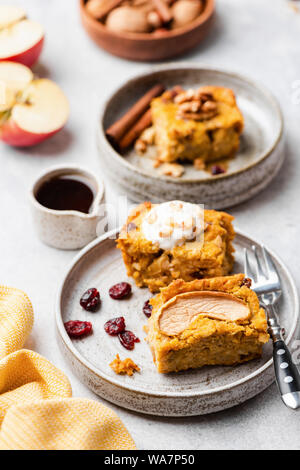 Sweet pumpkin cake with walnuts, cinnamon and dried cranberry cut in squares. Closeup view. Autumn comfort food Stock Photo