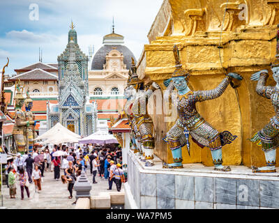 Golden monuments and Temple of Emerald Buddha, Grand Royal Palace in Bangkok, Thailand. Official residence of the Kings of Siam. Museum crowd tourists