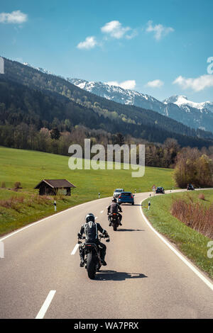 motorcyclist riding on meadow Stock Photo - Alamy