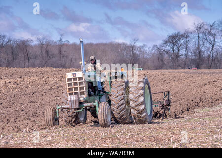 April 28 2018 Buchanan MI USA;  A farmer on his tractor plows a field during the plow days event in Michigan USA Stock Photo
