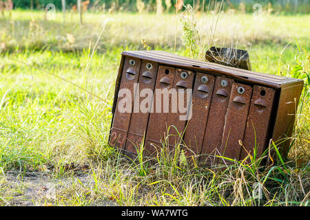 old rusty mailboxes in rural area on a green background Stock Photo